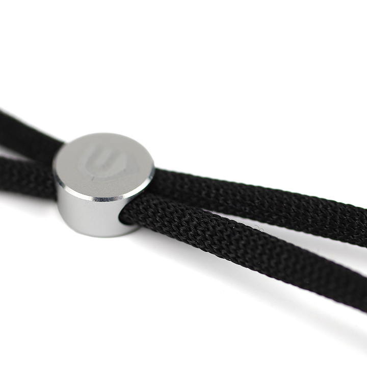 Close-up of a TPA black velvet braided cord with a metallic clasp on a white background