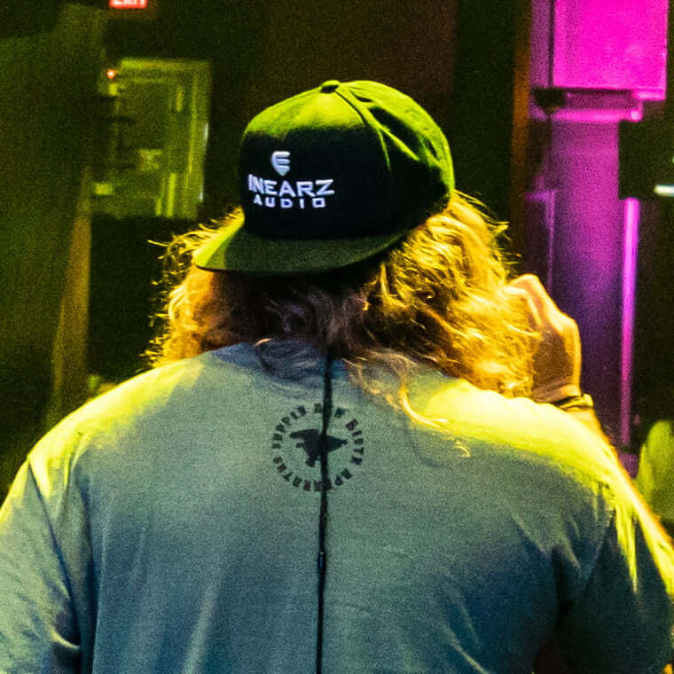 Inearz snapback hat with logo worn by musician